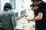 Team of three working through the visual design for change incorporated